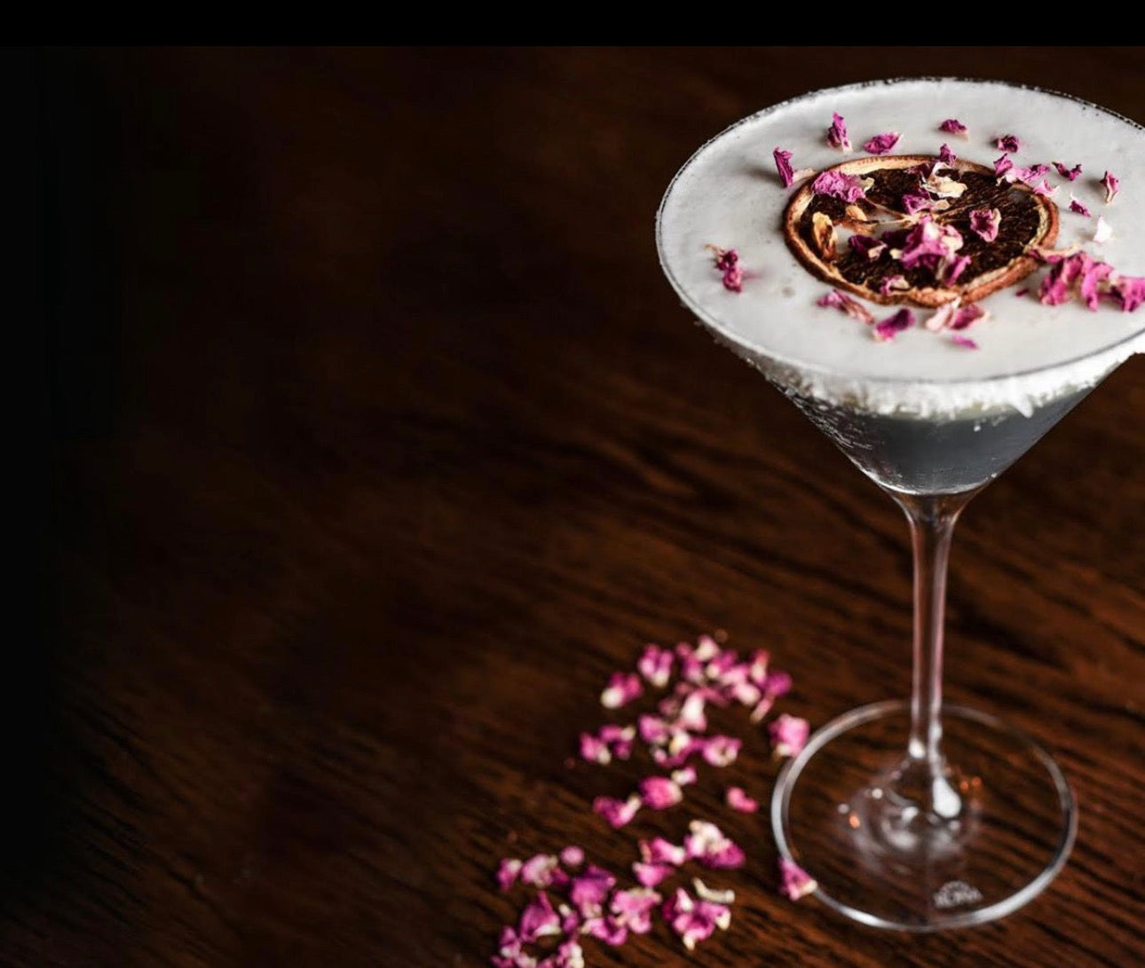 Edible roses in a cocktail with dehydrated fruit